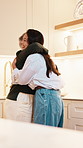 Mother, hug and adult daughter in house with love, reunion and bonding together for weekend visit. Happy, mature mom and woman embrace in kitchen with care, trust and family connection for wellness.