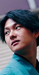 Travel, fashion and asian man with vision in city for culture, style or clothing tradition in kimono. Thoughtful, male person or ambition with stylish garment or sight for heritage in Japan or town