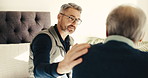 Caregiver, man and old person in bedroom of retirement  home for healthcare, discussion or support. People, health worker and senior care with elderly patient for conversation, recovery or advice