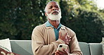 Senior, phone or black man with chest pain for cardiac arrest, heart attack or hypertension. Elderly, male person or ache with smartphone on sofa for health risk, medical emergency or asthma in yard