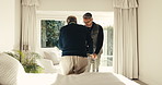 Caregiver, help and old person with walker in home for support, assistance or physical therapy. Man, senior patient with a disability and frame in assisted living facility for physio and recovery
