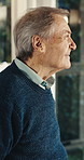 Thinking, window and senior man in home with reflection, memory or reminder of retirement. Remember, smile and elderly person in house with nostalgia, choice or decision on pension in living room.