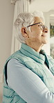 Thinking, happy and senior woman in home with reflection, memory or reminder of retirement. Remember, smile and elderly person in house with nostalgia, choice or decision on pension in living room.