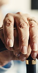 Hands, cane and elderly person in home for thinking, healing and osteoporosis in retirement. Closeup, thoughtful and pensioner with walking stick for balance, support and wellness for assisted living