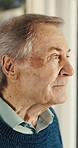 Thinking, window and senior man in house with reflection, memory or reminder of retirement. Remember, serious and elderly person in home with nostalgia, choice or decision on pension in living room.