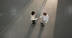 Business people, team and handshake in meeting, discussion or agreement for real estate opportunity. Above, space and shaking hands with realtor, colleagues and approval for property investment