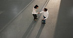 Business people, teamwork and handshake with smile in meeting, agreement or real estate opportunity. Above, space and shaking hands with realtor, happy colleagues and approval for property investment