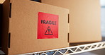 Shelf, boxes and logistics in warehouse with fragile label for shipping care or ecommerce safety. Cardboard, package sticker and distribution inventory, goods and protection caution in storage room