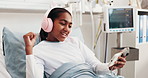 Headphones, dance and child in hospital bed with music, playlist and radio subscription in clinic. Happy, healthcare and girl on cellphone for streaming, audio and good mood for surgery recovery