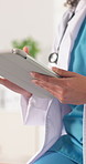 Doctor, hands and scroll in office with tablet, medical research and email for disease test results. Woman, healthcare worker and typing in clinic with digital tech, planning or report for diagnosis.