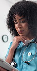 Doctor, woman and thinking in hospital with tablet, medical research and site for telehealth chatbot. Healthcare worker, person and reading in clinic with tech, problem solving or AI for admin tasks.