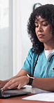 Doctor, woman and typing in hospital with laptop, online research or health insurance administration. Healthcare worker, person and browsing in clinic with computer, medical aid policy and report.