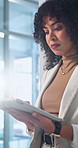 Businesswoman, walk and scroll in office with tablet, email and check compliance for finance audit. Accountant, person and reading in firm with tech, online financial statement and evaluation report.