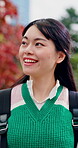 Student, thinking and walking with woman in park for campus search, reflection and travel explore. College tour, perspective and happy with person outdoor for location, journey and vision in Japan