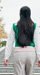 Student, thinking and back with woman in park for campus search, reflection and travel explore. College tour, perspective and walk with person on steps for location, journey and vision in Japan