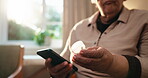 Hands, medicine and old woman with phone in home, prescription pills or checking side effects on web. Wellness, treatment and senior person with drugs, online and searching for dosage tips on mobile