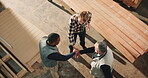 Carpentry, above or team in warehouse with handstack, support and motivation for furniture project. Happy, people and engineers with handshake, encouragement and solidarity in woodworking workshop.
