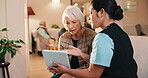 Caregiver, tablet and consultation for old woman in lounge, talking or explaining healthcare update. Assisted living, nurse and chat with senior person, online and review medical diagnosis with tech