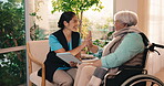 Nurse, tablet and high five with old woman in wheelchair for bonding, elderly care and support. Happy, retirement home and online rehabilitation progress with senior person with a disability
