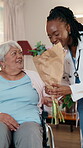 Health, wheelchair or old woman with flowers to doctor for treatment success, gratitude or homecare. Medical, happy worker or bouquet from senior person with disability for recovery, thank you or hug