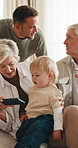 Playing, sofa and grandparents with baby and phone for bonding, watching videos or visit on weekend. Family, home and senior people with child on cellphone for connection, streaming or relax together