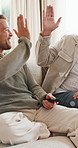 Happy, high five and senior man with son watching tv with remote control, celebration and talking. Father, adult offspring and clap for esport victory, bonding and entertainment on home sofa