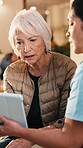Healthcare, old woman or nurse with tablet in home for care plan, symptom tracking or service. Talk, senior patient and caregiver with tech in homecare for health records, medical update and explain