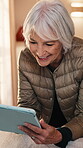 Senior, woman and happy with tablet in home for ebook subscription, web novel and download. Digital library, elderly person and smile with tech in house for chapter release, reading app and streaming