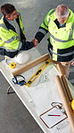 Architecture, above and men with blueprint, handshake and agreement for building, design and layout. Construction, contractor and people with sketch, shaking hands and remodeling plan for renovation