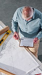 Construction, above and man with blueprint, clipboard and paperwork for building, design and layout. Architecture, contractor and mature person with report, sketch and remodeling plan for renovation