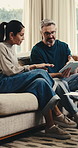 Mature, couple or finance with tablet in home for online investment, network or connection. Man, woman or discussion with technology on sofa for financial decision, option or choice together in house