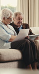 Senior, couple and documents with tablet for finance, retirement insurance or investment in home. Elderly, man and woman with technology or invoice for pension, expenses or bills together in house