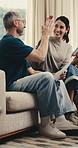 Mature, documents and happy couple with high five for finance, budget success or investment in home. Excited, man and woman with smile, paperwork or tablet on sofa for financial achievement in house