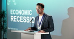 Businessman, presentation and talk in seminar with advice, projector and economic recession update. Economist, person and speaking in conference for inflation issue, financial crisis and fall of GDP.