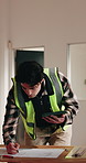 Contractor, tablet and blueprint for construction site, inspection check or renovation assessment. Man, tech and online checklist for remodeling, floor plan and notes for property development