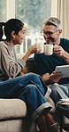 Cheers, coffee and tablet with couple on sofa for booking success, bonding and flight registration. Connection, online holiday discount and toast with mature man and woman in living room in home