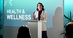 Woman, presentation or podium with speech for healthcare, medical awareness campaign or event. Female person, speaker or seminar with audience or company pitch for workshop, health and wellness