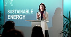 Woman, presentation and podium with speech for sustainable energy or eco friendly campaign launch. Female person, speaker or environmentalist talking with crowd in seminar for natural business growth