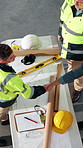 Construction, above and men with blueprint, handshake and agreement for building, design and layout. Architecture, contractor and people with sketch, shaking hands and remodeling plan for renovation