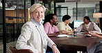 Boardroom, face and businesswoman with team, laughing and financial advisor with career development. Happy, executive and mature person with colleagues, discussion and meeting with group in business