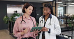 People, doctors and reading at hospital with tablet, research and medical report for diagnosis. Women, team and discussion in workplace with digital, patient history and healthcare case for treatment