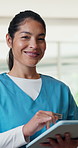 Face, tablet and medical doctor at clinic for healthcare service, telehealth and communication. Tech, happy and woman with uniform in hospital for guidelines, support and internet for advice