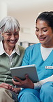 Talking, tablet and nurse with elderly woman for consulting, healthcare review and medical checkup. Happy, nursing home and caregiver with person on tech for good results, assisted living or wellness