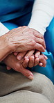 Empathy, nurse or old woman in house with holding hands, comfort or consoling for medical diagnosis. Health, senior patient or caregiver with support, understanding or sympathy for evaluation results