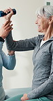 Happy, old woman or dumbbell exercise for physio, mobility improvement or functional screening. Clinic, worker or senior person with weights, physical therapy or fitness assistance in rehabilitation