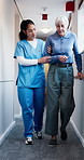 Nurse, support and walk with old woman for physiotherapy, rehabilitation and recovery help. Retirement, medical or assistance for physical therapy with happy patient, talk and gait training in clinic