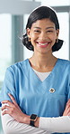 Face, woman and happy nurse with confidence for healthcare service, career integrity and about us. Portrait, medical worker and female person with smile, arms folded and values with flare in hospital