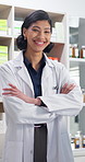 Face, woman and happy pharmacist in pharmacy with confidence for healthcare, laugh or retail service. Arms crossed, medical and person in drug store, pharmaceutical medicine or smile with flare