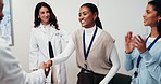 Handshake, meeting and woman with doctors in hospital office for grant, medical patent or research. Happy, applause and people with success, thank you or celebrate for healthcare milestone or funding