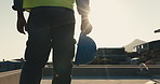 Man, walking and construction worker with hardhat outdoor for inspection, building or maintenance. Helmet, PPE and civil engineer on site for repairs, renovation or remodeling for quality control.